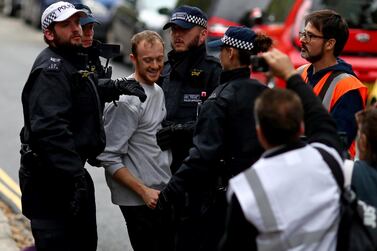 Police officers detain a man outside Lambeth County Court, during a raid on an Extinction Rebellion storage facility, in London, Britain October 5, 2019. REUTERS/Simon Dawson
