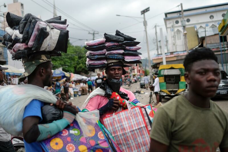 Street vendors selling plastic bags wait for customers during the strike. AP