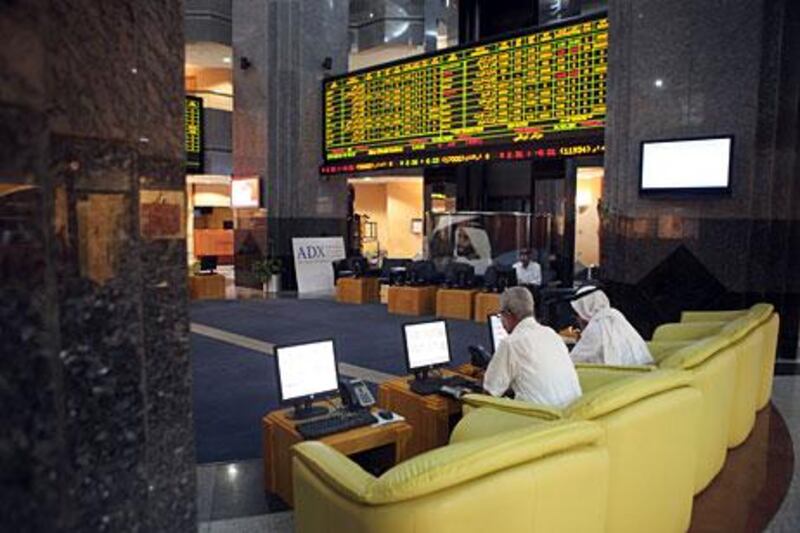 Traders at Abu Dhabi Securities Exchange watch the markets.