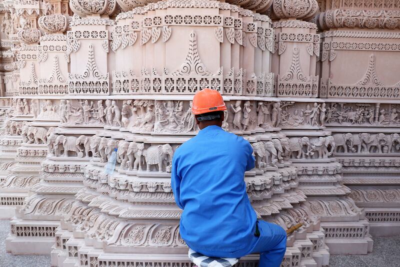 Workers putting final touches to the Baps Hindu Temple. Pawan Singh / The National