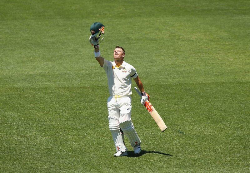 David Warner of Australia points to the sky after reaching his century on Day 1 of the first Test against India on Tuesday in Adelaide. Robert Cianflone / Getty Images / December 9, 2014 