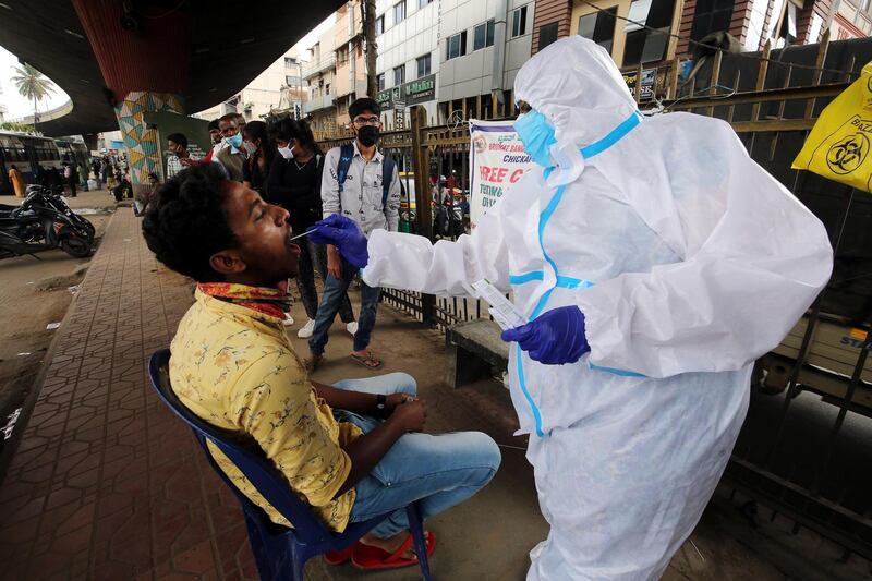 epa08668594 A health worker takes a swab sample from a person for a Covid-19 detection test in Bangalore, India, 14 September 2020. India has the second highest total of confirmed COVID-19 cases in world, reports state.  EPA/JAGADEESH NV