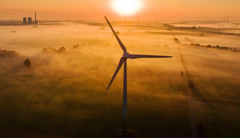 Wind turbines shoot out of the morning mist near Sehnde, Germany. Julian Stratenschulte / EPA