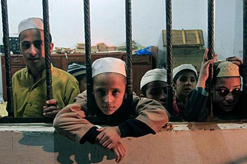 Children look through window of a room after being rescued by police during a raid at a self-styled Islamic seminary on the outskirts of Karachi yesterday.