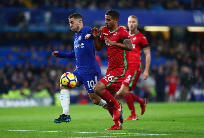 Chelsea forward Eden Hazard is challenged by Kyle Naughton.  Clive Rose / Getty Images