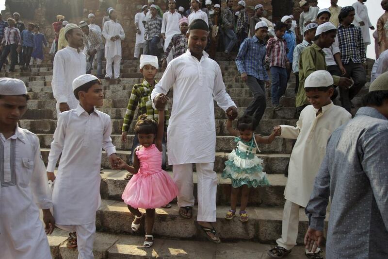 Indian Muslims return after offering prayers at the Ferozshah Kotla Mosque in New Delhi. Tsering Topgyal / AP Photo