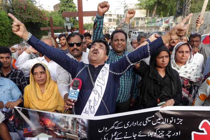 Protesters shout slogans during the protest against the mob attacks in Jaranwala.  EPA 