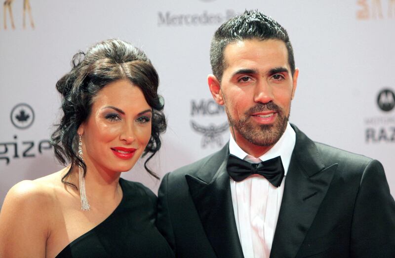(FILES) In this file photo taken on November 10, 2011 German-Tunisian rap singer Bushido (R) poses with his partner Anna Maria Lagerblom, now called Anna-Maria Ferchichi, as they arrive for the Bambi awards ceremony in Wiesbaden, Germany. - Berlin crime gangs of Arab origin have long earned infamy with gang violence and brazen robberies but now, police warn, they have targeted a new generation of refugees for recruitment. Germany's best-known rapper, Bushido, long boasted about his close ties to one Berlin clan -- until they had a falling out this year and he sought the protection of a rival group. (Photo by DANIEL ROLAND / AFP) / Germany OUT / TO GO WITH AFP STORY BY YANNICK PASQUET AND FRANK ZELLER