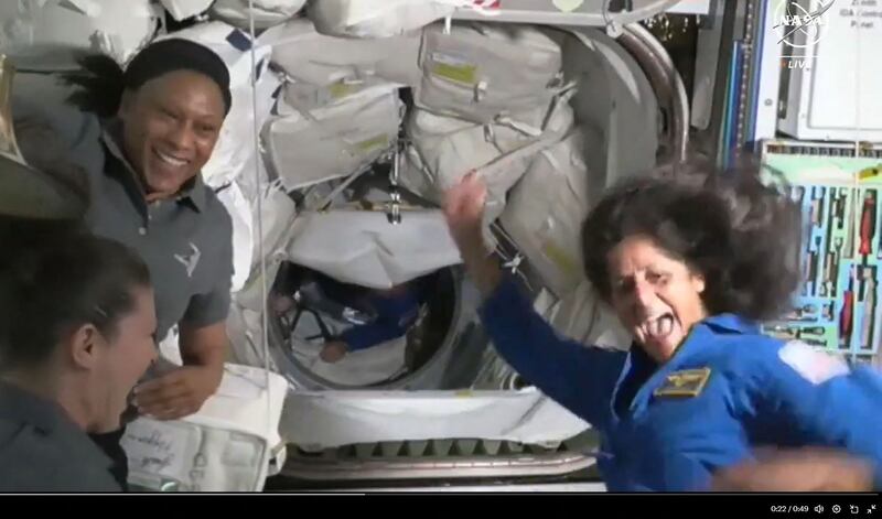 Nasa astronauts Suni Williams, right, and Butch Wilmore, in tunnel, arrive on board the International Space Station after travelling on Boeing's Starliner capsule. AFP