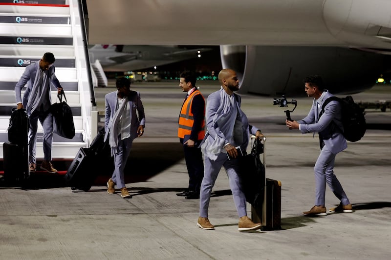 Dani Alves and his Brazil teammates member disembark from an aircraft upon arrival ahead of the World Cup Qatar 2022. Getty