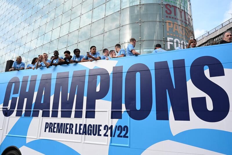 Manchester City's players on the an open-top bus parade. AFP