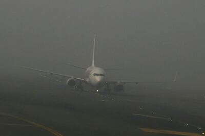 An aircraft prepares to take off in dense fog on a cold winter morning at Indira Gandhi International Airport in New Delhi in December 2023. 
 AFP
