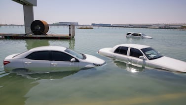 Cars submerged in water during last month's floods in Dubai. Experts say there are ways to spot flood damage on vehicles. Antonie Robertson / The National