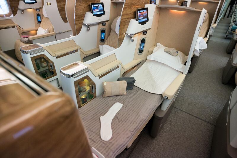 The business-class cabin has lie-flat seats and a personal minibar, but no sliding doors. Photo: Emirates