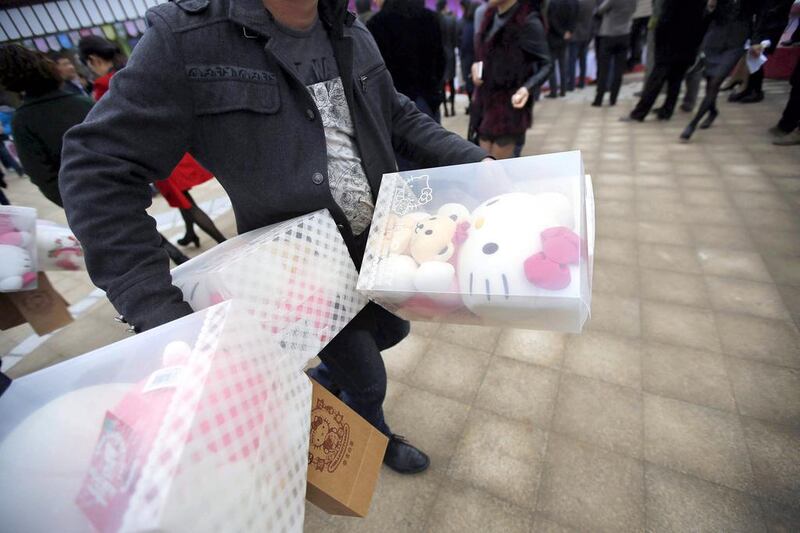 A man carries Hello Kitty toys during the inauguration ceremony of the first Hello Kitty amusement park outside Japan. The 150-acre theme park is expected to attract one million visitors each year. Carlos Barria / Reuters