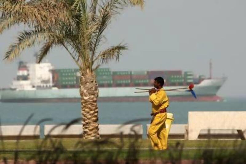 A foreign worker walks along Kuwait City’s corniche. The Kuwait government announced in March that it aimed to reduce the number of foreign workers in the country by 100,000 each year.