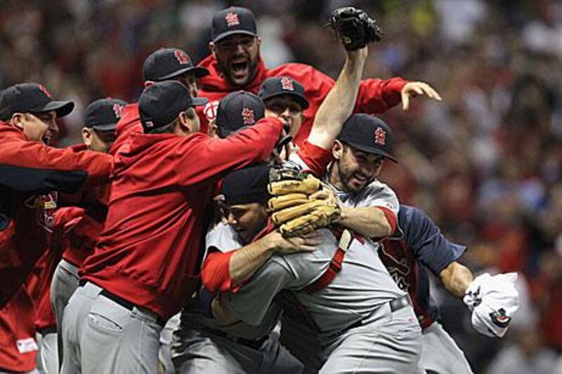 The St Louis Cardinals players celebrate after winning Game 6 12-6 against the Milwaukee Brewers to win the NLCS.