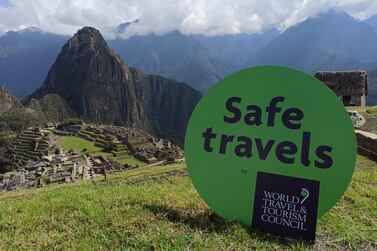 The 'Safe travels' seal in Machu Picchu, in Peru. The WTTC's urgent call for common standards on Covid-19 testing comes as airlines face a bleak winter season that will stretch their cash reserves and test their survival amid a second and third waves of infections. EPA 