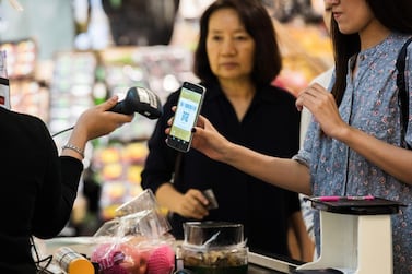 A customer uses a QR code on a mobile phone to pay for purchases. Bloomberg
