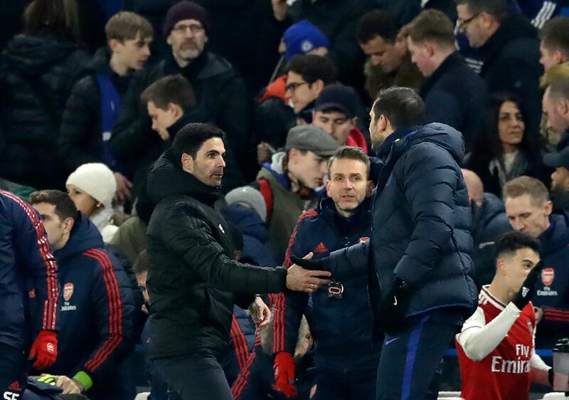 Mikel Arteta, left, shakes hands with Chelsea manager ead coach Frank Lampard. AP