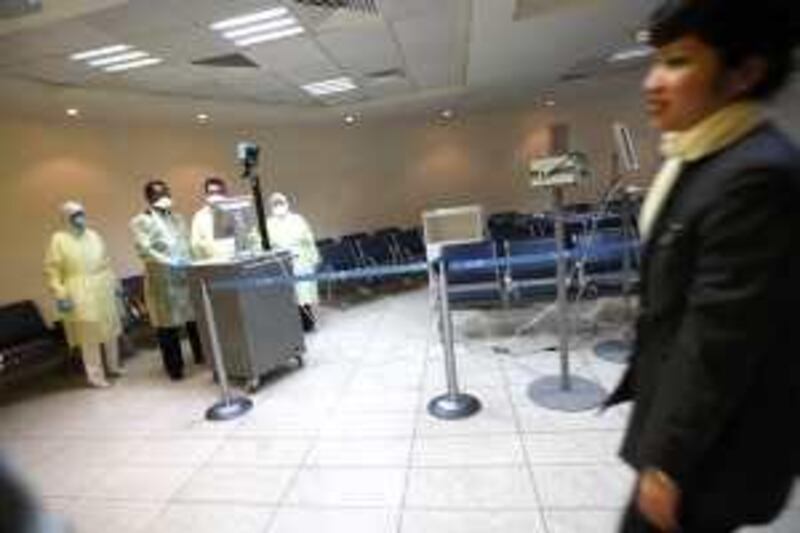 May 2, 2009 / Abu Dhabi / Health officials scan incoming passengers with an  infrared heat scanner designed to see if someone has a fever, a precaution against passengers entering Abu Dhabi with Swine Flu at the Abu Dhabi International Airport May 2, 2009.  (Sammy Dallal / The National)
 *** Local Caption ***  sd-050209-airport-03.jpg