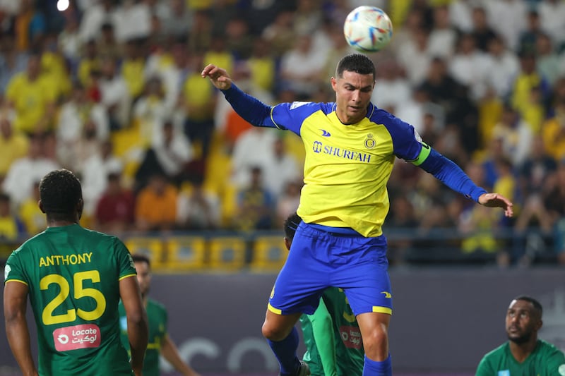Cristiano Ronaldo jumps for a header during the Saudi Pro League football match between Al Nassr and Al Khaleej.