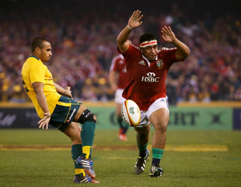 British and Irish Lions' Mako Vunipola (R) attempts to smother a kick from Australia Wallabies' Will Genia during their rugby union test match at the Etihad Stadium in Melbourne June 29, 2013. REUTERS/David Gray (AUSTRALIA  - Tags: SPORT RUGBY)   *** Local Caption ***  SGP125_RUGBY-LIONS-_0629_11.JPG