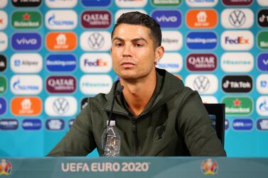 epa09275477 A handout photo made available by the UEFA shows Portugal's Cristiano Ronaldo with a bottle of water during the Portugal Press Conference ahead of the UEFA Euro 2020 Group F match between Hungary and Portugal, at Puskas Arena in Budapest, Hungary, 14 June 2021 (issued 16 June 2021). EPA/UEFA HANDOUT Strictly for Editorial Use Only. No use in publications devoted solely to any single team, player and/or match. Use in online, mobile and/or apps must be comparable to that in a newspaper or permitted magazines and books Getty Images provides access to thi HANDOUT EDITORIAL USE ONLY/NO SALES