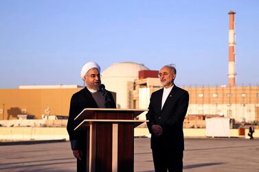 President Hassan Rouhani, left, speaks as he is accompanied by the head of Iran's Atomic Energy Organization, Ali Akbar Salehi, on a visit to the Bushehr nuclear power plant in southern Iran. AP