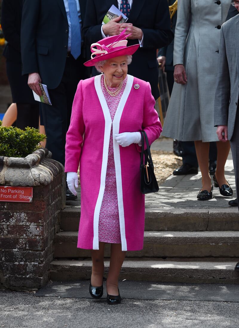 Queen Elizabeth II, wearing pink, during her visit to Berkhamsted School as part of its 475th anniversary celebrations on May 6, 2016, in Berkhamsted, England. Getty Images