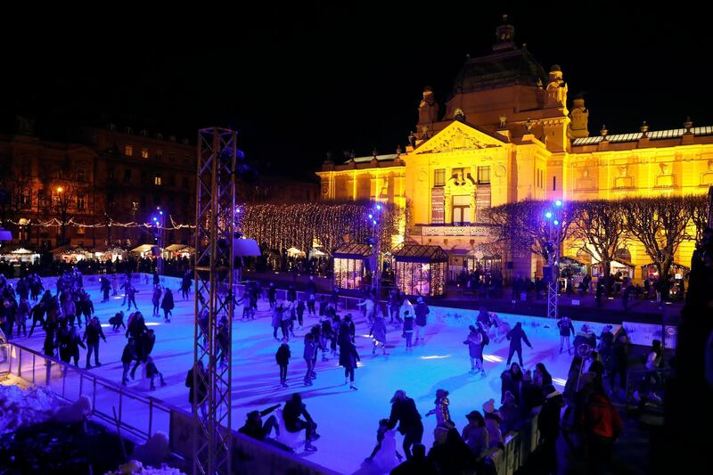 People skate on an outdoor ice rink during the Christmas market in Zagreb, Croatia. EPA