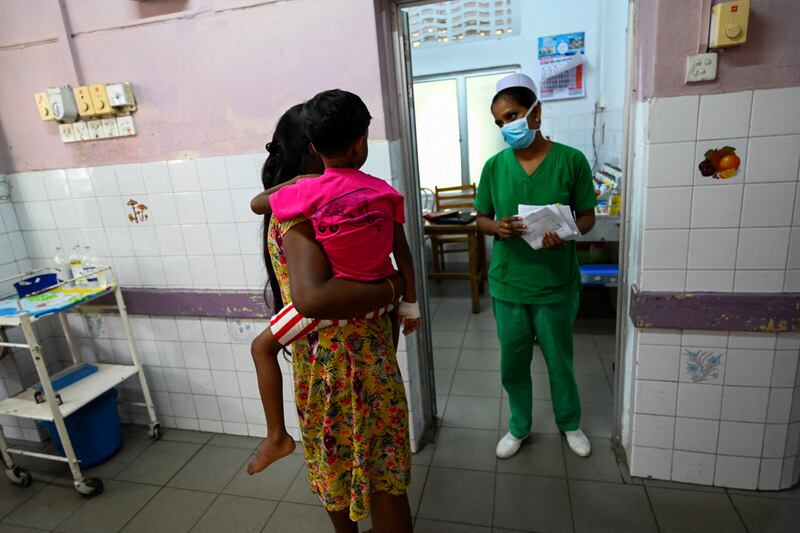 A mother with her child speaks to a nurse in Lady Ridgeway Hospital for Children. AFP