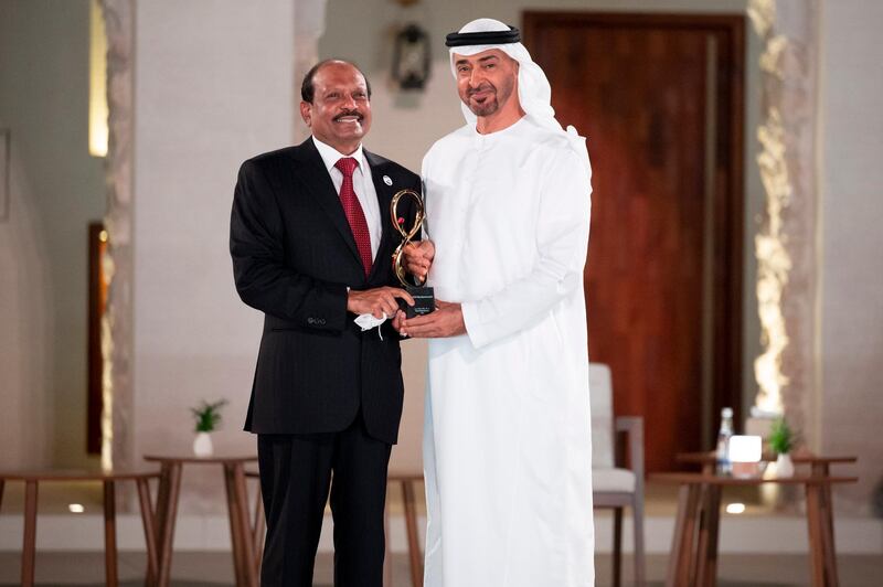 ABU DHABI, UNITED ARAB EMIRATES - April 07, 2021: HH Sheikh Mohamed bin Zayed Al Nahyan, Crown Prince of Abu Dhabi and Deputy Supreme Commander of the UAE Armed Forces (R), presents an Abu Dhabi Award to Yusufali Musaliyam Veettil (L), during an awards ceremony, at Qasr Al Hosn.

( Mohamed Al Hammadi / Ministry of Presidential Affairs )
---