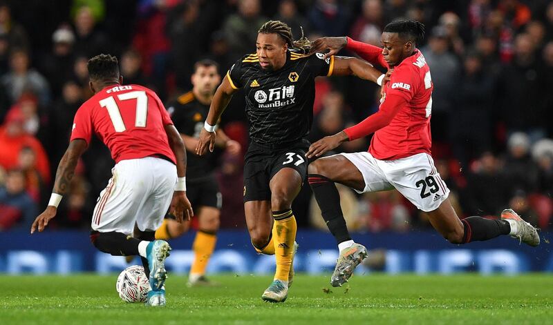 Wolverhampton Wanderers' Spanish striker Adama Traore (C) vies with Manchester United's Brazilian midfielder Fred (L) and Manchester United's English defender Aaron Wan-Bissaka during the English FA Cup third round-replay football match between Manchester United and Wolverhampton Wanderers at Old Trafford in Manchester, north west England, on January 15, 2020. RESTRICTED TO EDITORIAL USE. No use with unauthorized audio, video, data, fixture lists, club/league logos or 'live' services. Online in-match use limited to 120 images. An additional 40 images may be used in extra time. No video emulation. Social media in-match use limited to 120 images. An additional 40 images may be used in extra time. No use in betting publications, games or single club/league/player publications.
 / AFP / Paul ELLIS / RESTRICTED TO EDITORIAL USE. No use with unauthorized audio, video, data, fixture lists, club/league logos or 'live' services. Online in-match use limited to 120 images. An additional 40 images may be used in extra time. No video emulation. Social media in-match use limited to 120 images. An additional 40 images may be used in extra time. No use in betting publications, games or single club/league/player publications.
