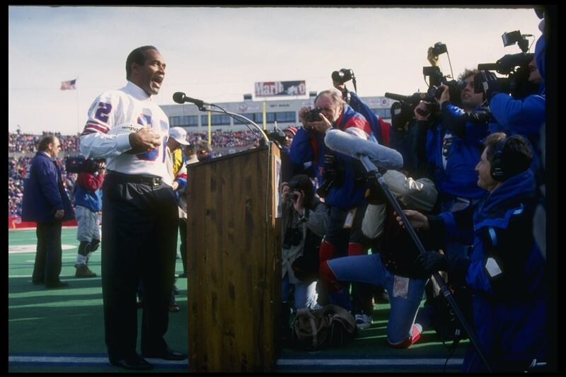 Simpson speaks during a half-time ceremony during a game between the Buffalo Bills and the Indianapolis Colts in November 1993. Allsport / Getty Images