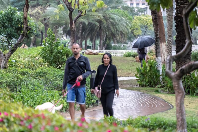 DUBAI, UNITED ARAB EMIRATES. 10 JANUARY 2020. Heavy rains in Dubai during the night had residenst wake up to wet pavements and large water puddles with some areas experiencng mild flooding. Residents of The Greens enjoy their morning walk in the earlt drizzle. (Photo: Antonie Robertson/The National) Journalist: Standalone. Section: National.

