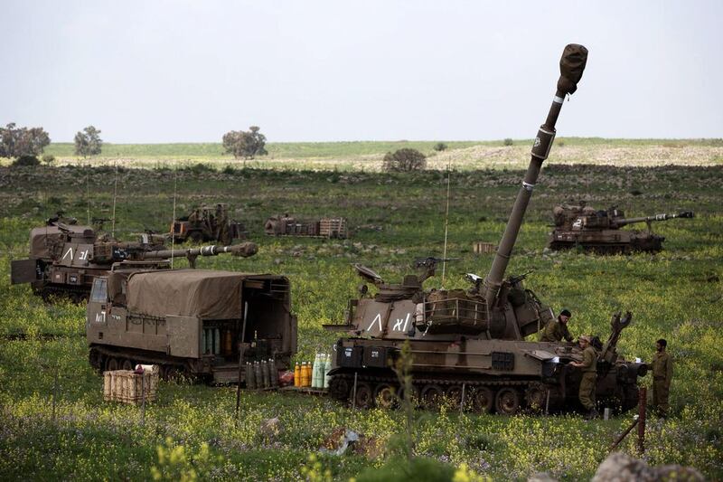 An Israeli Army artillery unit is deployed on alert near the border with Syria on March 19, in the Israeli-annexed Golan Heights. Menahem Kahana / AFP Photo