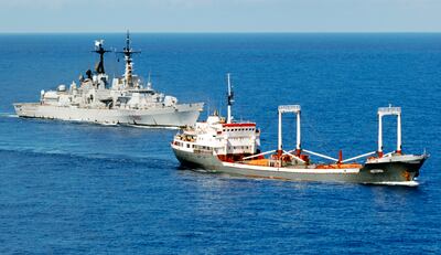 An Italian naval destroyer escorts a merchant vessel delivering humanitarian assistance to Somalia in the Indian Ocean in 2008. Reuters