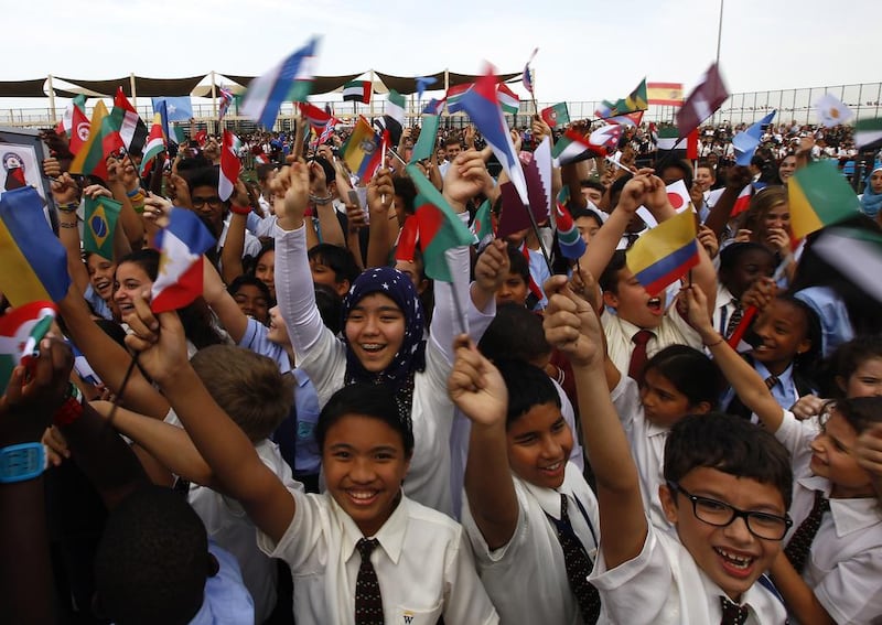 Most nationalities singing a National Anthem: The students of Gems Wellington Academy in Dubai celebrating after setting the record. Jeffrey E Biteng / The National