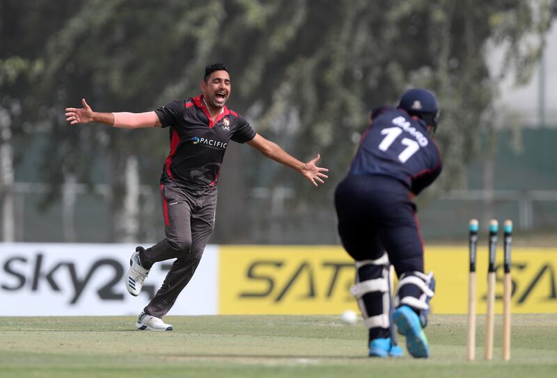 UAE's Zahoor Khan takes the wicket of Namibia batsman Stephan Baard. 