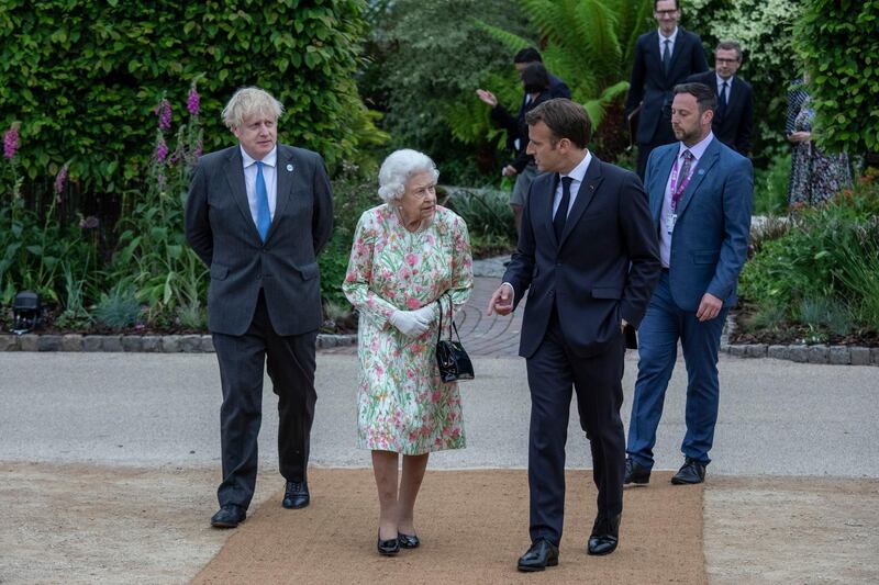 French President Emmanuel Macron, Queen Elizabeth II, British Prime Minister Boris Johnson and US President Joe Biden arrive at a drinks reception during the G7 Summit. Getty Images