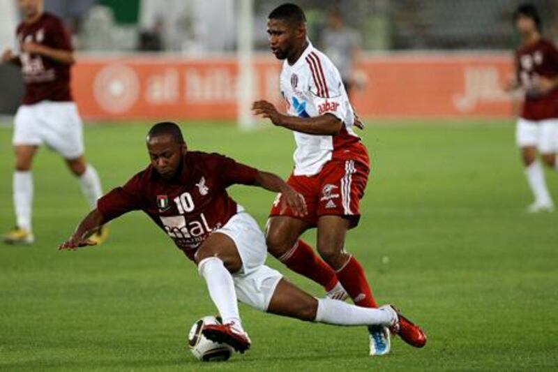 
ABU DHABI, UNITED ARAB EMIRATES Ð April 11,2011: Ismael Matar (no 10) of Al Wahda Club and Subait Khater (no 24 right) of Al Jazira club in action during the President Cup football match at Zayed Sports City football stadium in Abu Dhabi. (Pawan Singh / The National) For News. Sports
