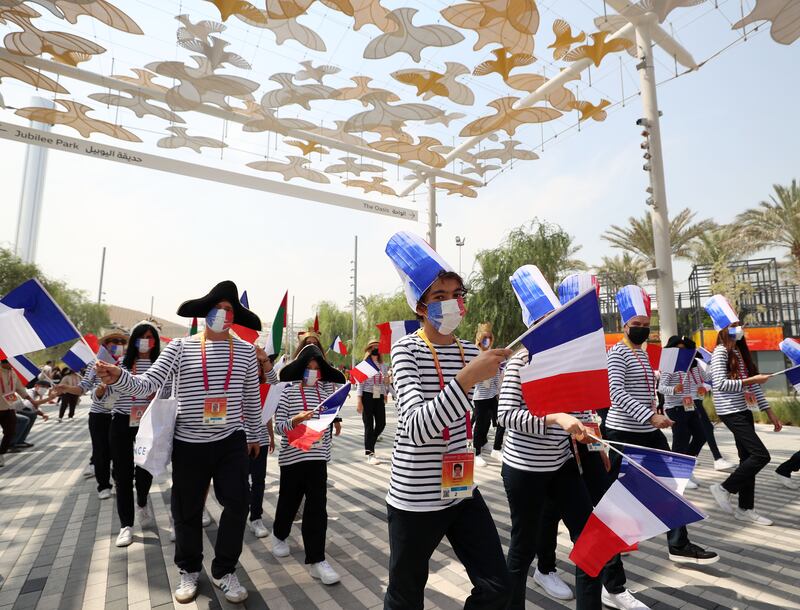 People parade on French national day at Expo 2020, Dubai. Chris Whiteoak / The National