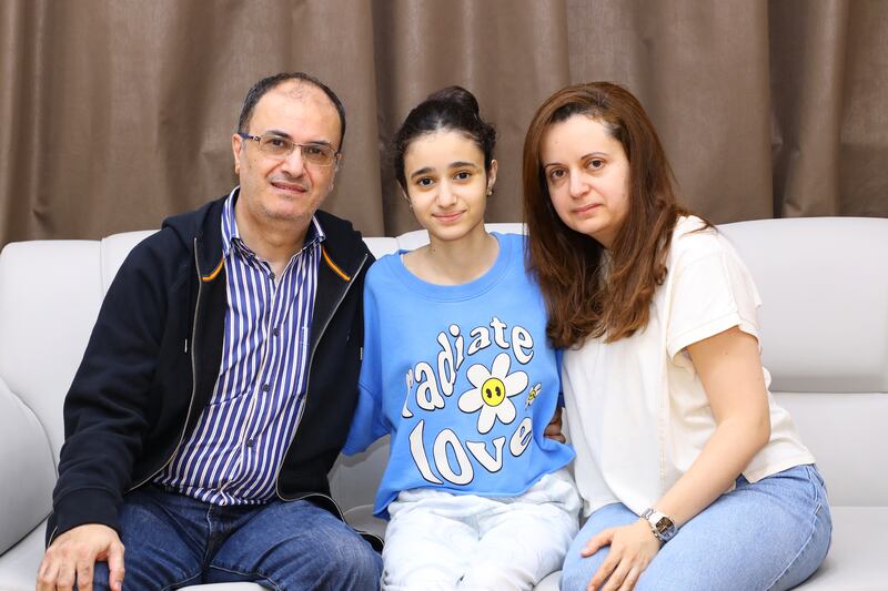 The first vertebral body tethering procedure was performed on Salma Naser Nawayseh, centre, with her parents, at Burjeel Hospital in Dubai