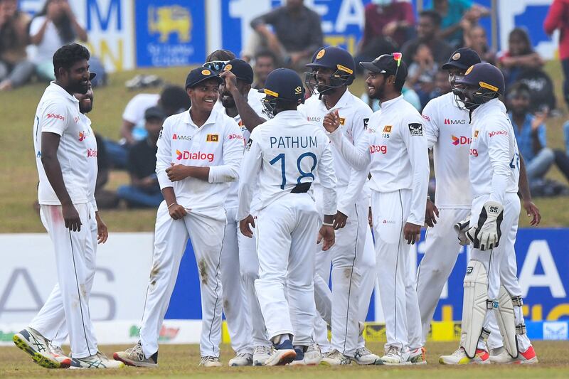 Sri Lanka's Dunith Wellalage, second left, celebrates with teammates after catching out Pakistan opener Abdullah Shafique for 16. AFP