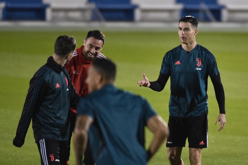 Ronaldo (R) speaks to teammates during a training session in Riyadh. AFP