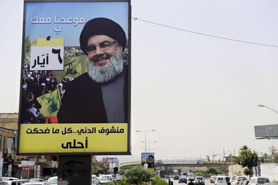 A portrait of chief of the Lebanese Hezbollah movement, Hassan Nasrallah, is fixed on the side of a road in the mainly Shiite Muslim southern suburbs of Beirut on May 4, 2018, ahead of the weekend's legislative elections. Arabic on the poster reads: "We see the world nicer when you smile".
Lebanon elects its parliament for the first time in nine years on Sunday, with its ruling parties seeking to preserve a fragile power-sharing arrangement despite regional tensions. / AFP PHOTO / JOSEPH EID