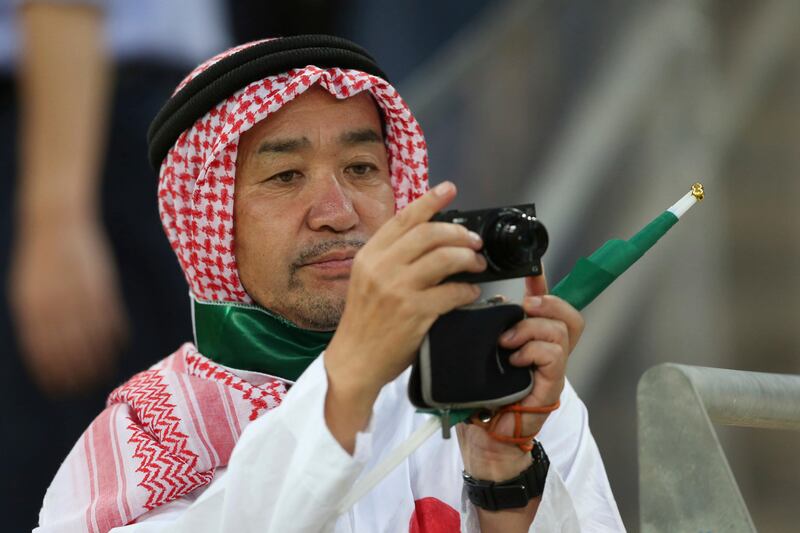 
                  A Japanese fan wears Saudi traditional clothes takes a picture during the 2018 World Cup group B qualifying soccer match between Saudi Arabia and Japan in Jiddah, Saudi Arabia, Tuesday, Sept. 5, 2017. (AP Photo)
               