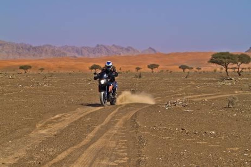 The KTM 990 SMT powers forward on a sandy track near Wadi Sharm - Paolo Rossetti for The National