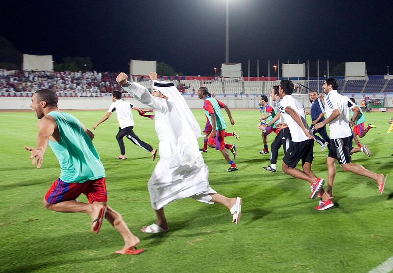 Members of the Al Shaab team run onto the pitch at the end of their game with Al Dhafra in Al Ain.

Credit: Mike Young/The National